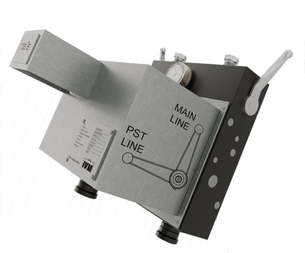 Close-up of IVM industrial valve with main and PST line labels, pneumatic actuator, and pressure gauge.